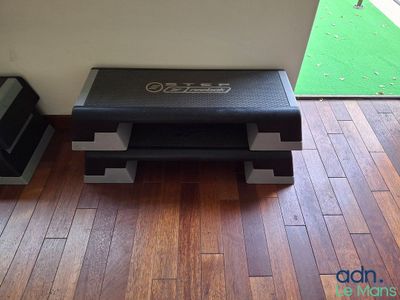 un banc noir posé sur un parquet dans une pièce