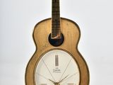 a guitar shaped clock sitting on top of a table