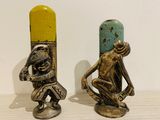 two figurines of a man and a woman sitting on a table
