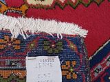 a close up of a red and blue rug with a tag on it