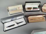 a lot of different pens in a box on the table