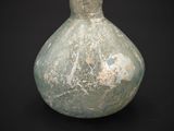 a green vase that is sitting on a black surface