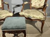 two chairs and a foot stool sitting on a tiled floor