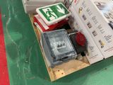 boxes of electrical equipment are stacked on a pallet on a green floor