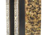 the two books are sitting side by side on a white surface