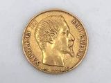 a close up of a gold coin on a white surface