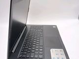 a laptop computer sitting on a table with a keyboard