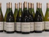 six bottles of wine are lined up in a row on a table