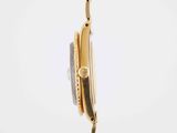 an image of a gold wrist watch with a chain around it