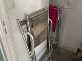 a towel rack in the corner of a bathroom next to a door