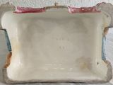 a small white bowl with a handle on a table