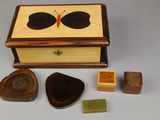 a small wooden box with a butterfly on top of it