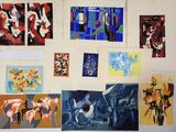 many paintings hanging on the wall of a room