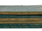 several books stacked on top of each other on a white surface