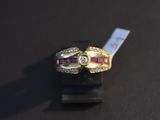 a gold ring with a ruby and a diamond on it