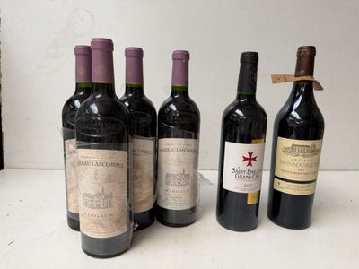 several bottles of wine are lined up on a table