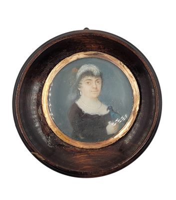 portrait of a woman in a black dress with a bird in her hand