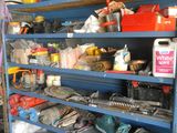 a blue shelving with lots of tools on top of it