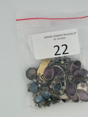 a bag of assorted jewelry on a white table