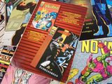 many comic books on a table with a lot of them