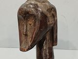 a hand that is holding a wooden stick with a horse head on it