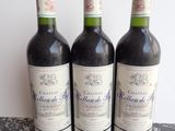 three bottles of wine sitting on top of a table next to each other