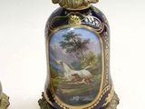 pair of vases with a painting of a horse and a dog on them