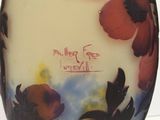 a vase with a picture of flowers painted on it
