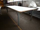 a long table with a white top in a room