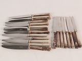 a lot of knives that are sitting on a table