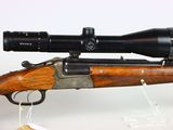 a rifle with a scope mounted on top of it