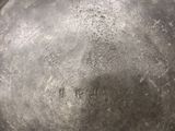 a close up of a silver plate with writing on it