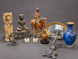 a lot of different statues and vases on the table