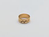 a close up of a gold ring on a white surface