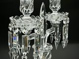 three crystal candlesticks on a black background