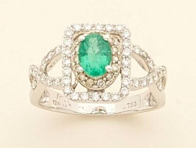 an image of a ring with a green stone surrounded by white diamonds