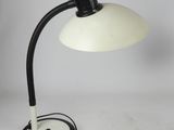 a black and white desk lamp with a white shade on it