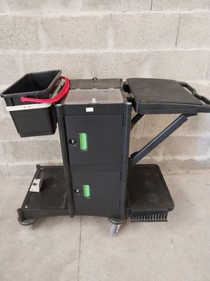 a black cart with a trash can on top of it