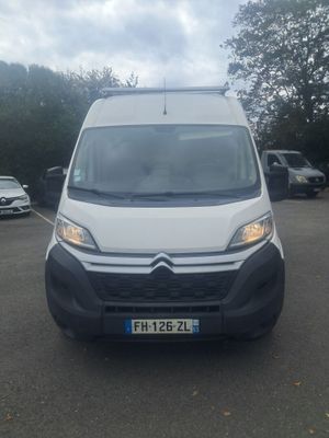 the white van is parked in the parking lot near other cars