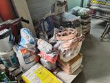 a lot of boxes and bags of supplies in a garage