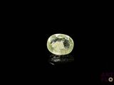 a close up of a green and white diamond on a black surface