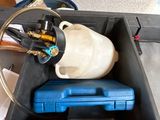 a picture of a blue box with a gas can and a hose attached to it
