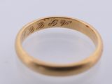 a close up of a gold ring on a white surface