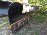 a large black plow sitting in the grass