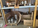 many boxes and cans on the floor of a garage