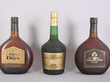 three bottles of liquor sitting next to each other on a table