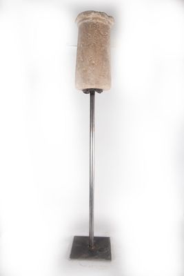 a stone vase on a metal stand on a white background