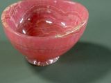 a pink bowl that is sitting on a table