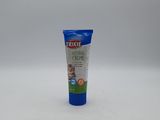 un gros plan d'un tube de dentifrice posé sur une surface blanche