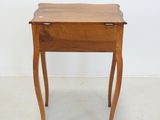 a small wooden table with a drawer on it